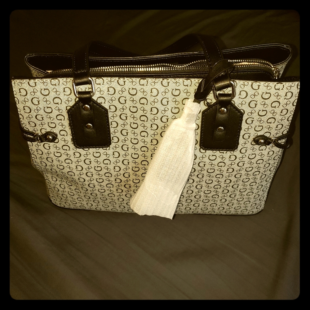 Grey handbag with logo print pattern.